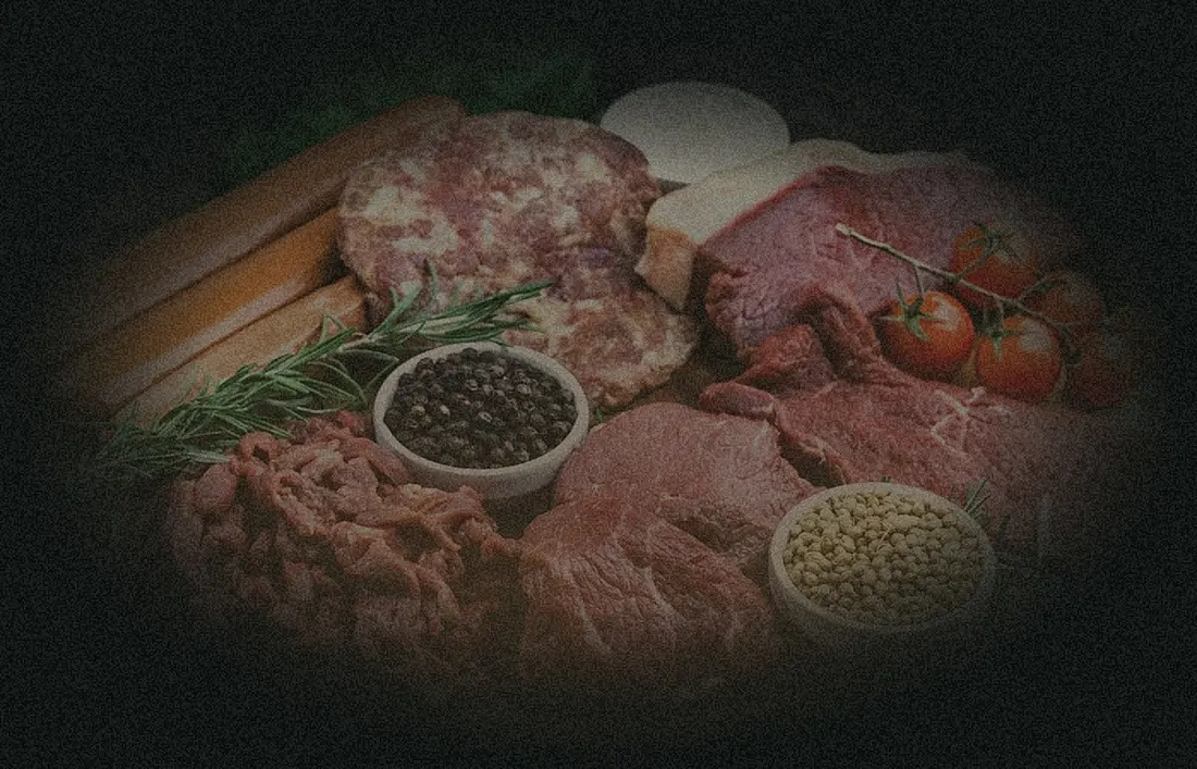 Fresh cuts of venison and meat on a butcher board
